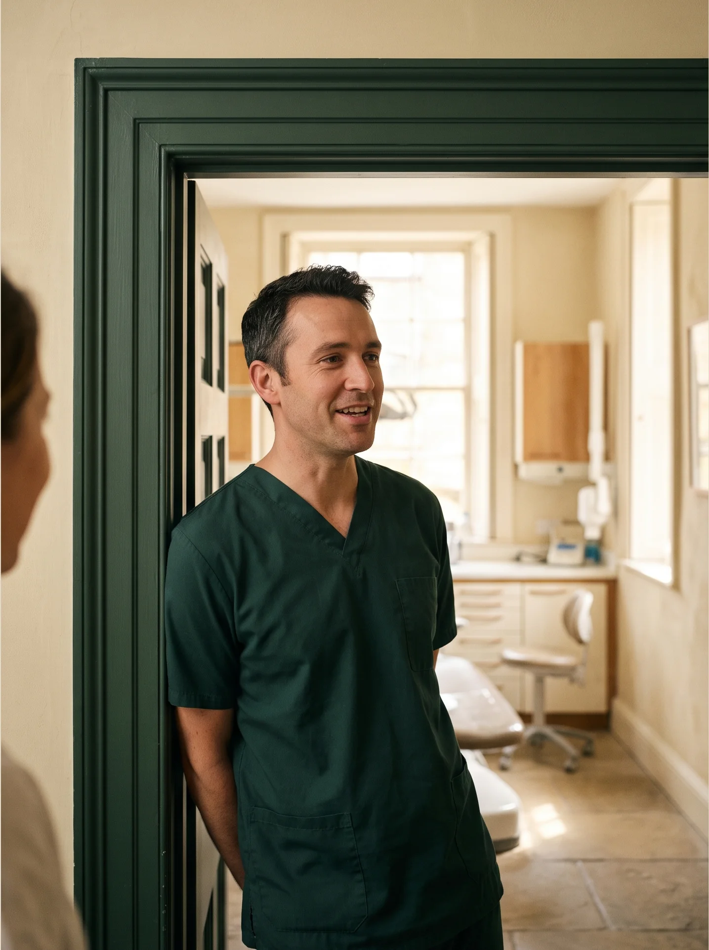Dr Sam Hart in the doorway of his surgery, talking to someone in the hall